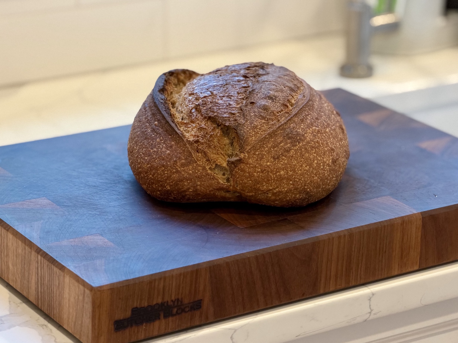 Plain country loaf on a wooden cutting board