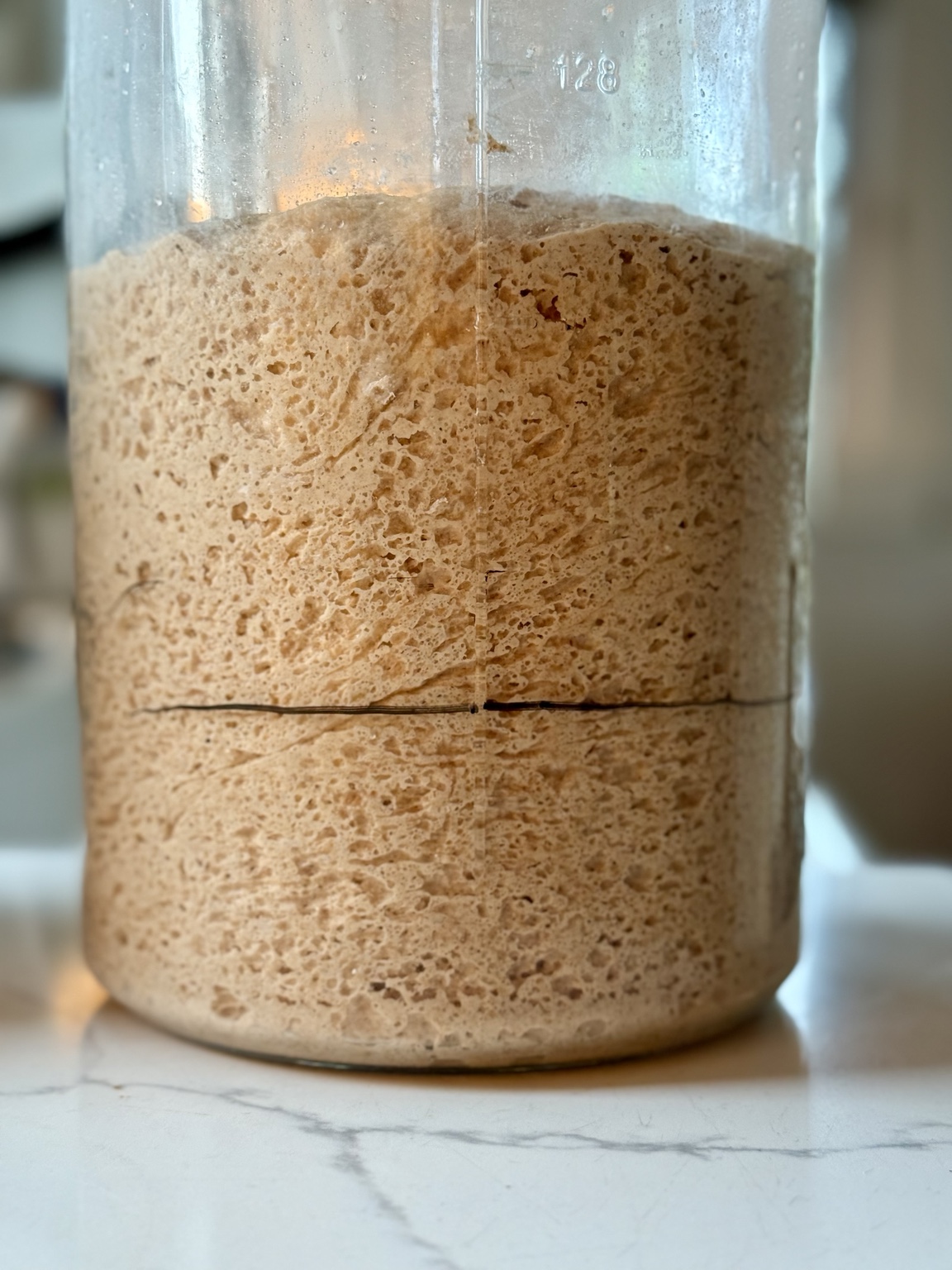 Active sourdough starter in a glass jar